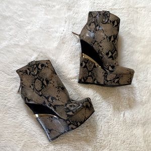 Extremely high heeled snake skin wedge booties